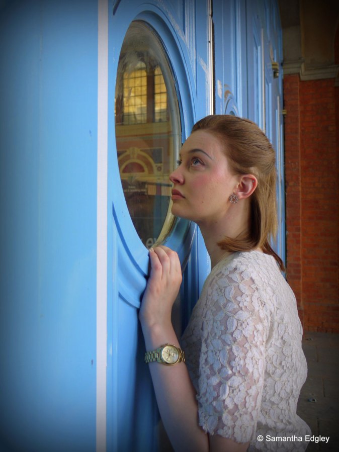 Helen peers through a window