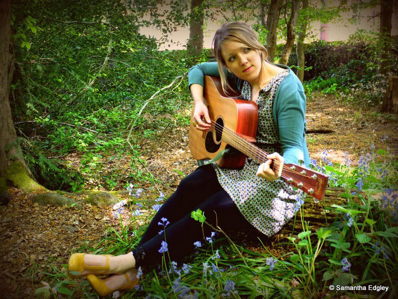 Rachel playing guitar at Highgate Woods